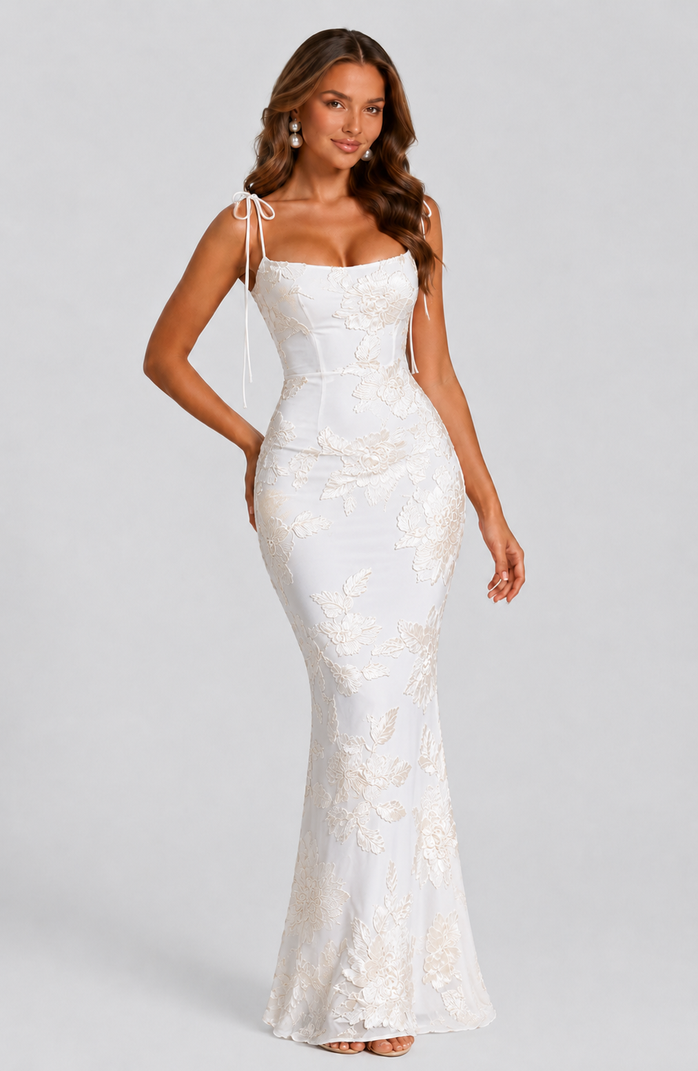 Woman wearing a white lace dress on a gray background