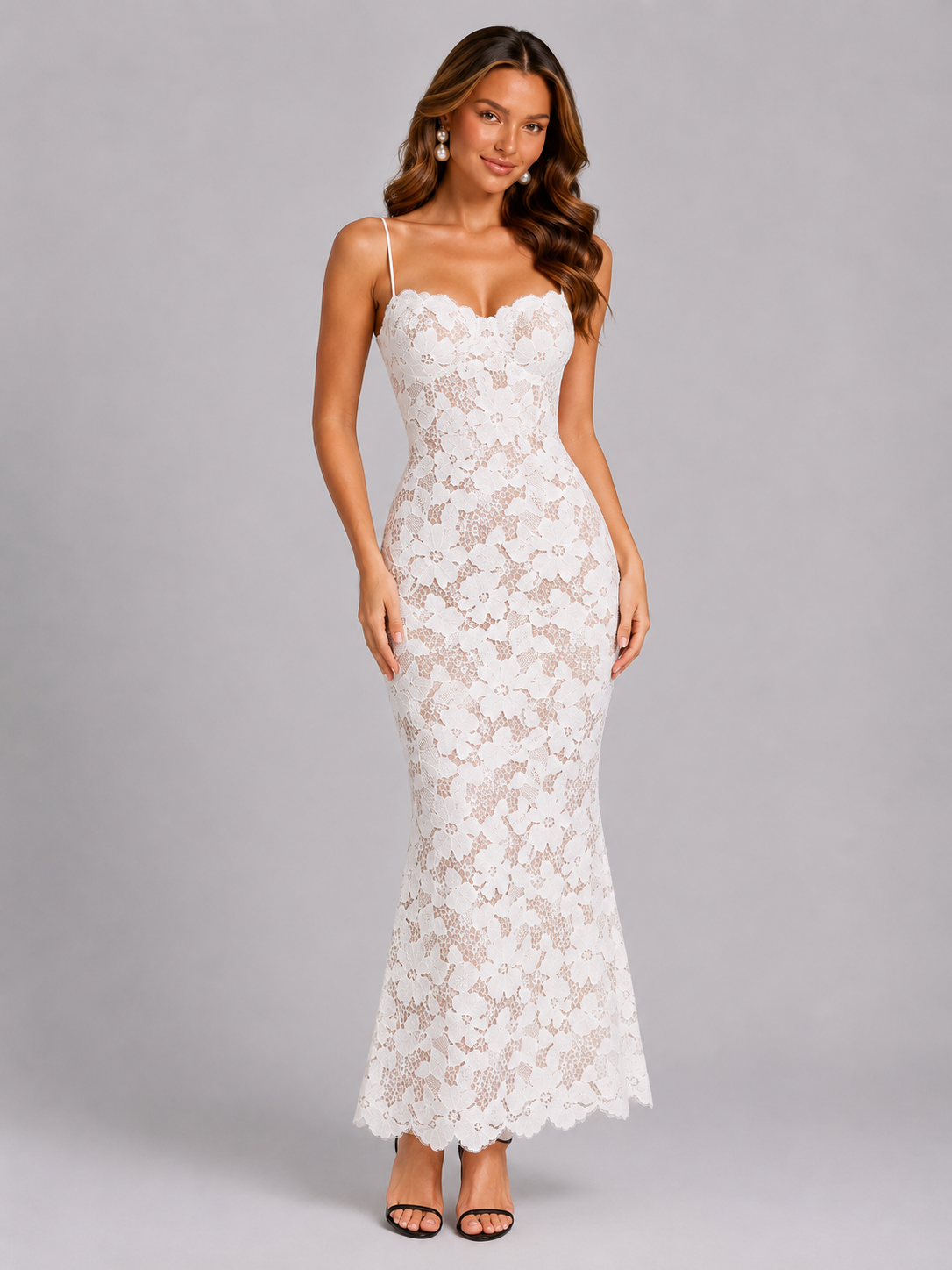 Woman wearing a white lace dress on a gray background