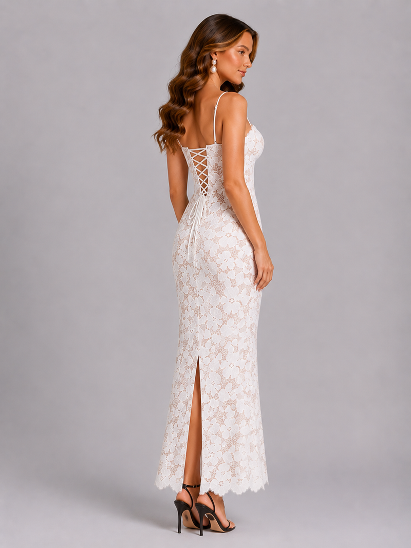 Woman wearing a white lace dress with a backless design on a gray background