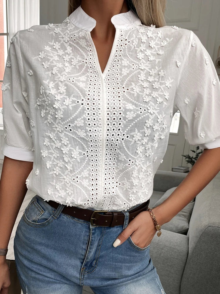 White lace blouse with short sleeves worn by a person indoors.