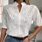 White lace blouse with a blurred indoor background