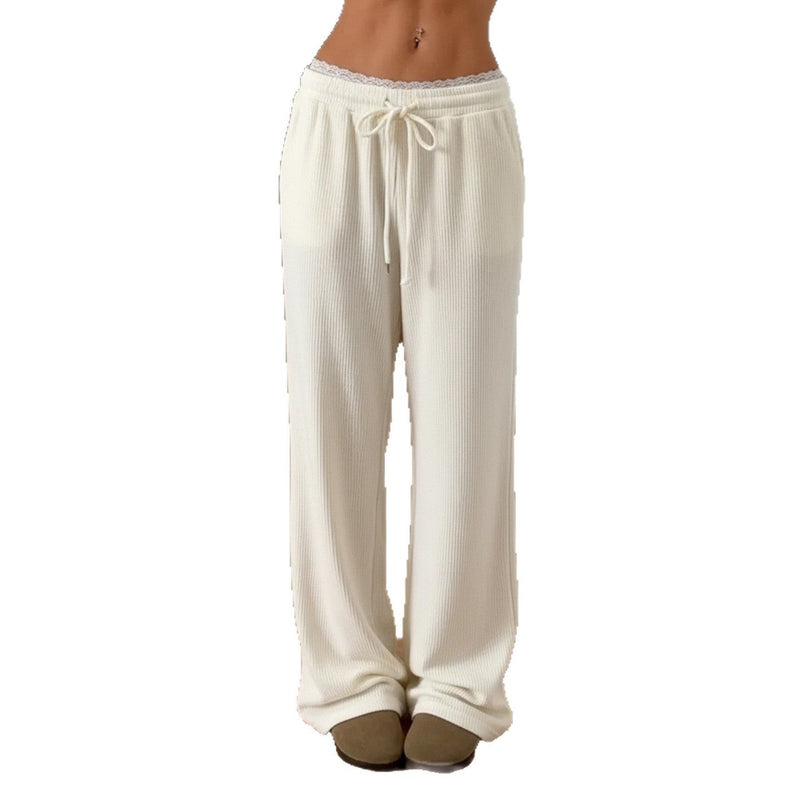 White wide-leg pants with a drawstring waist on a white background