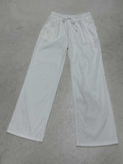 White sweatpants on a gray concrete floor