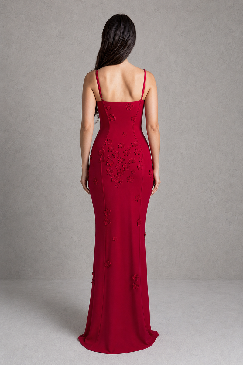 Red evening gown with floral embellishments on a gray background