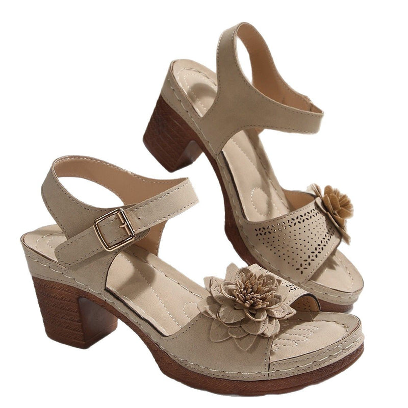 Beige high-heeled sandals with floral decorations on a white background