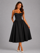 Woman wearing a black dress against a gray background