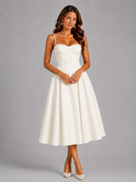Woman wearing a white dress against a gray background