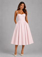 Woman wearing a pink dress against a gray background
