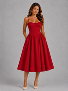 Woman wearing a red dress against a gray background