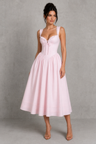 Woman wearing a pink dress against a gray background