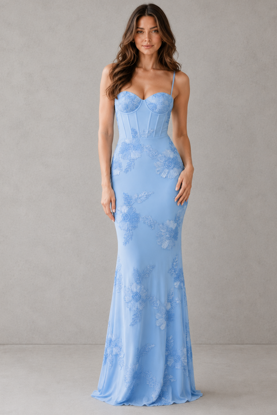 Woman wearing a light blue floral dress against a gray background