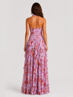 Woman wearing a floral strapless dress on a white background