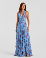 Woman wearing a blue floral dress on a white background