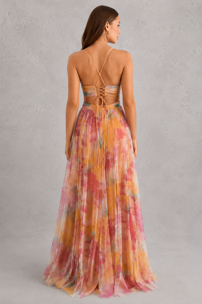 Woman wearing a colorful floral dress with a gray background