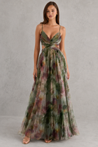 Woman wearing a floral dress against a gray background