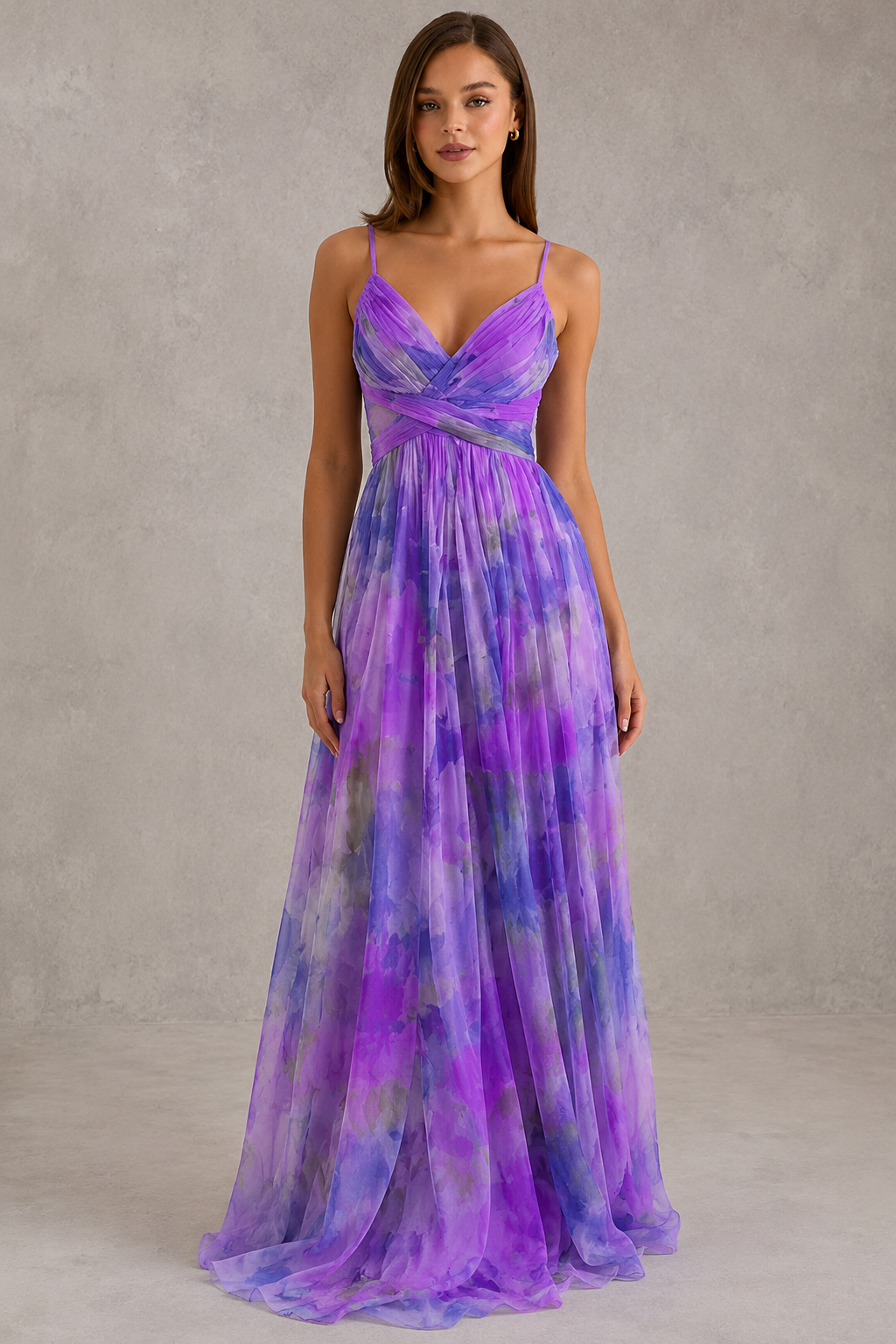 Woman wearing a purple and blue gradient evening gown against a neutral background