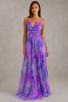Woman wearing a purple and blue gradient evening gown against a neutral background