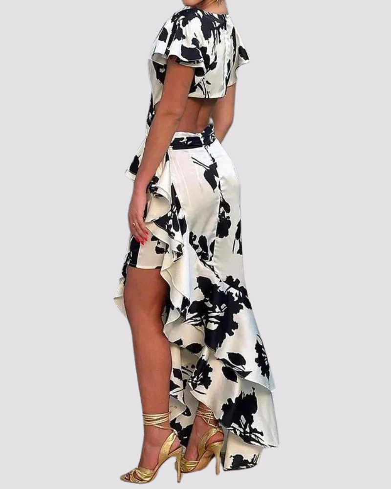 Woman wearing a black and white floral dress on a light gray background