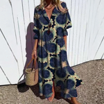 Woman wearing a floral dress with a white wooden fence background