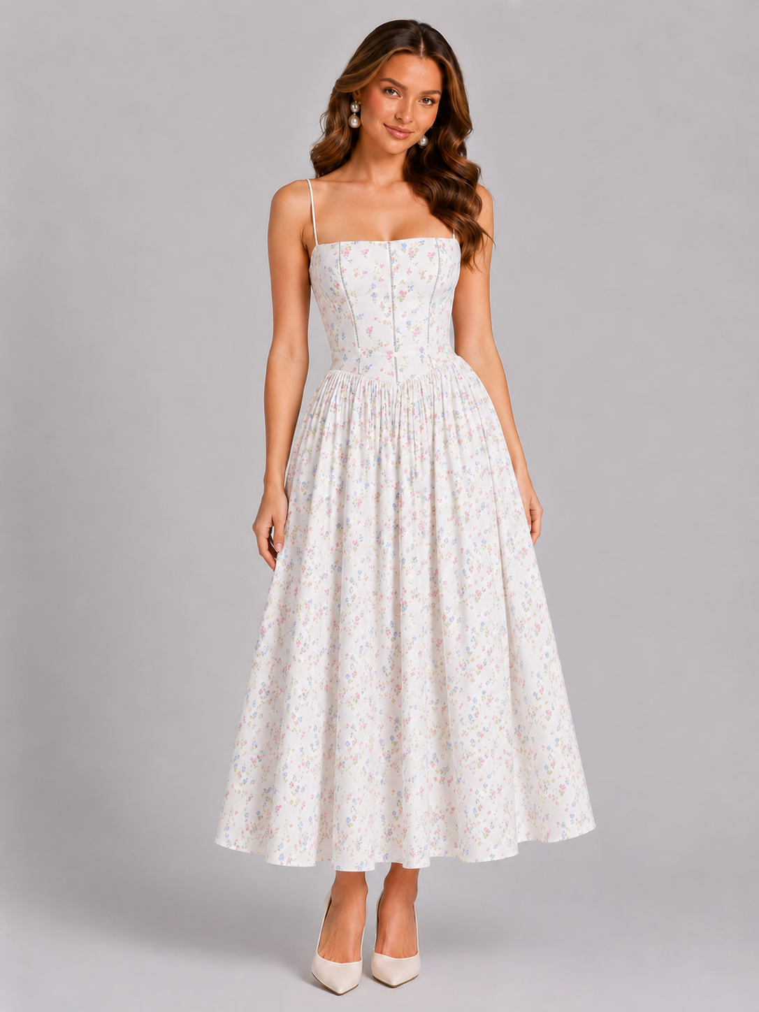 Woman wearing a white floral dress against a gray background