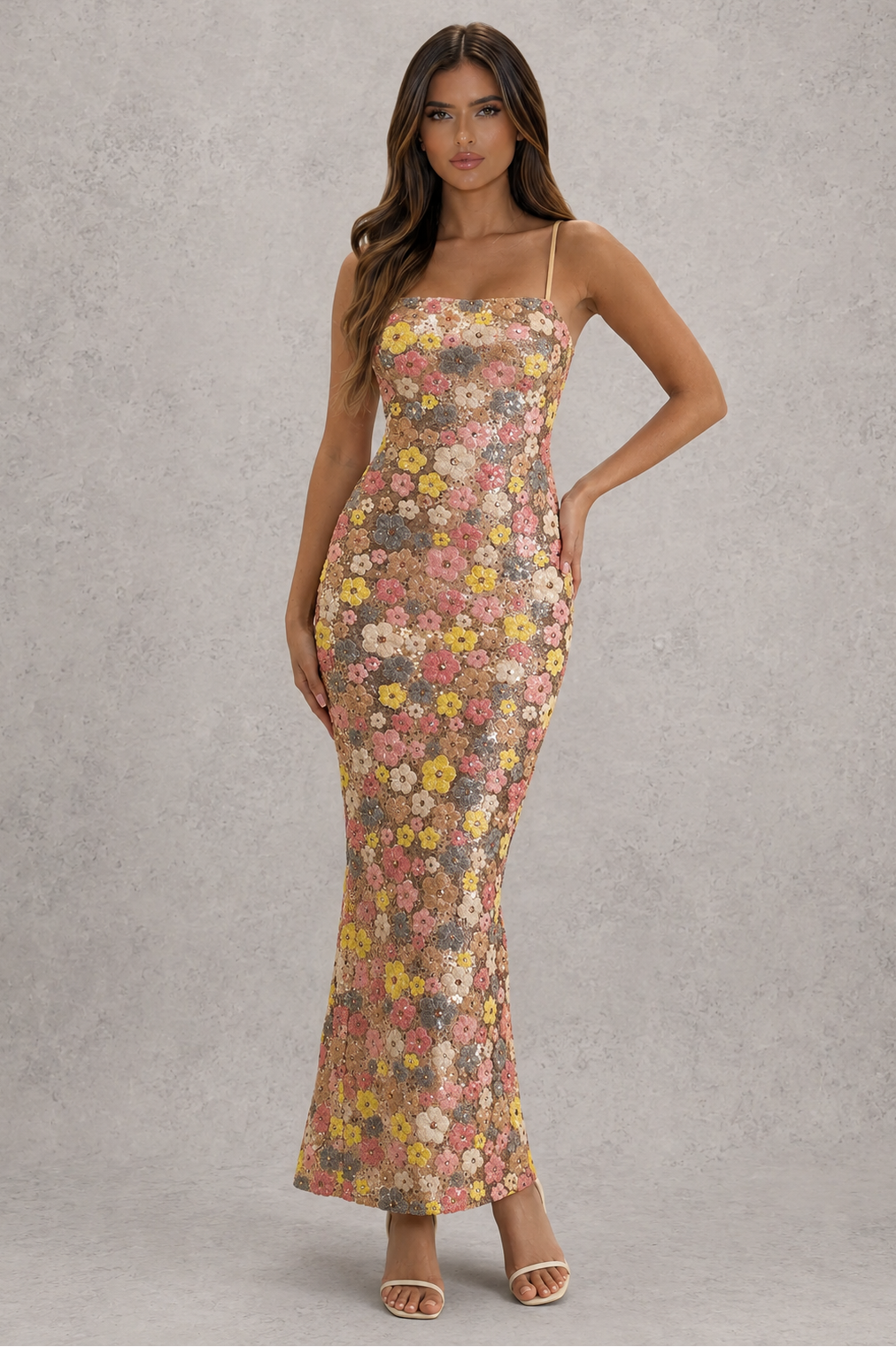 Woman wearing a floral dress against a gray background