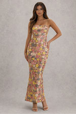 Woman wearing a floral dress against a gray background