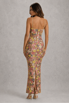 Woman wearing a floral dress with a gray background