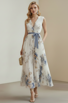 Woman wearing a floral dress with a plain background