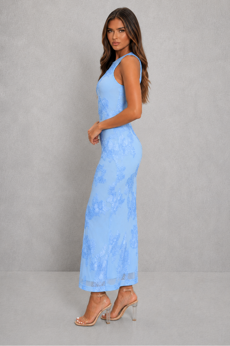 Woman wearing a light blue lace dress against a gray background