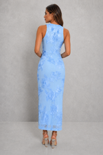Woman wearing a light blue lace dress against a gray background