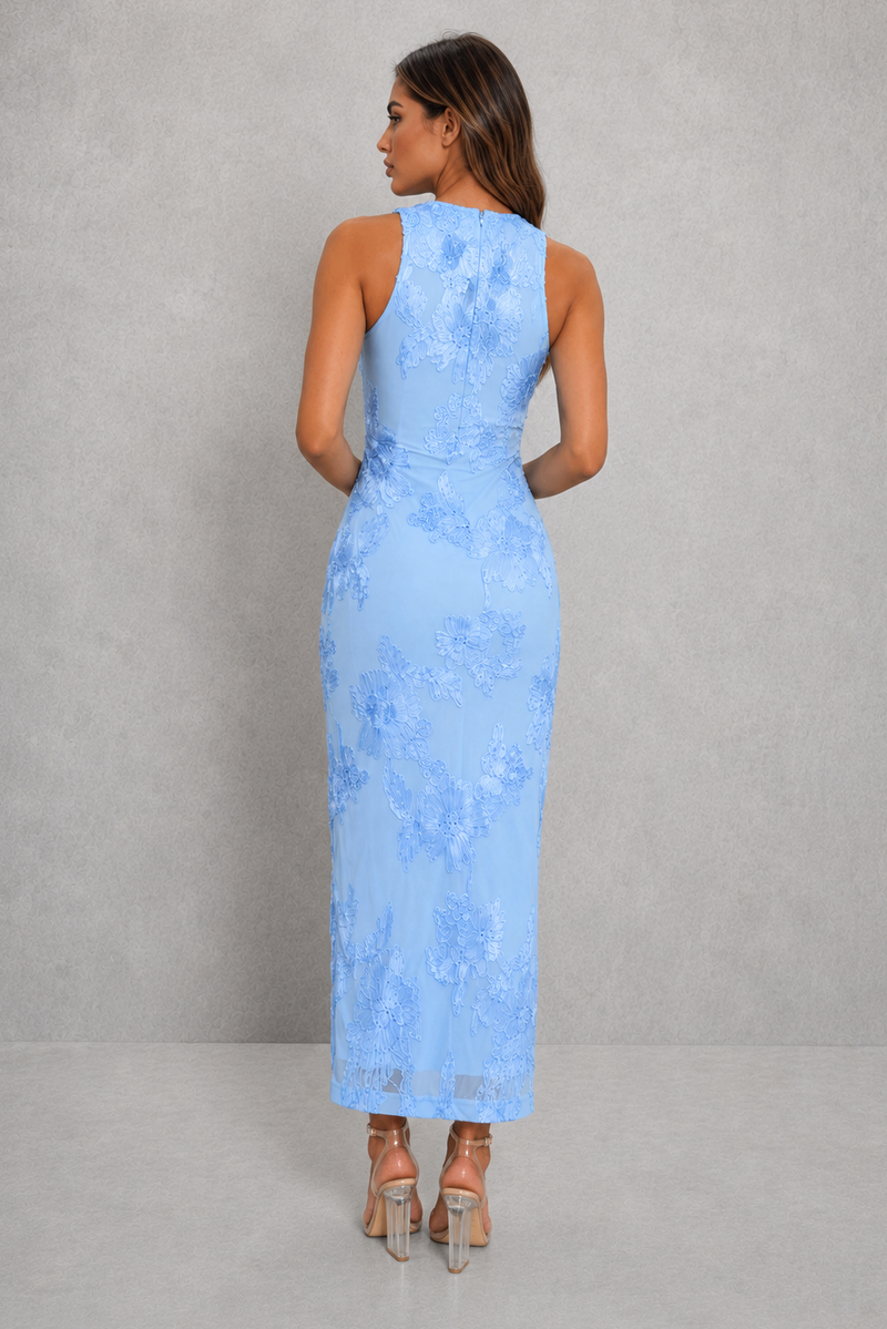 Woman wearing a light blue lace dress against a gray background