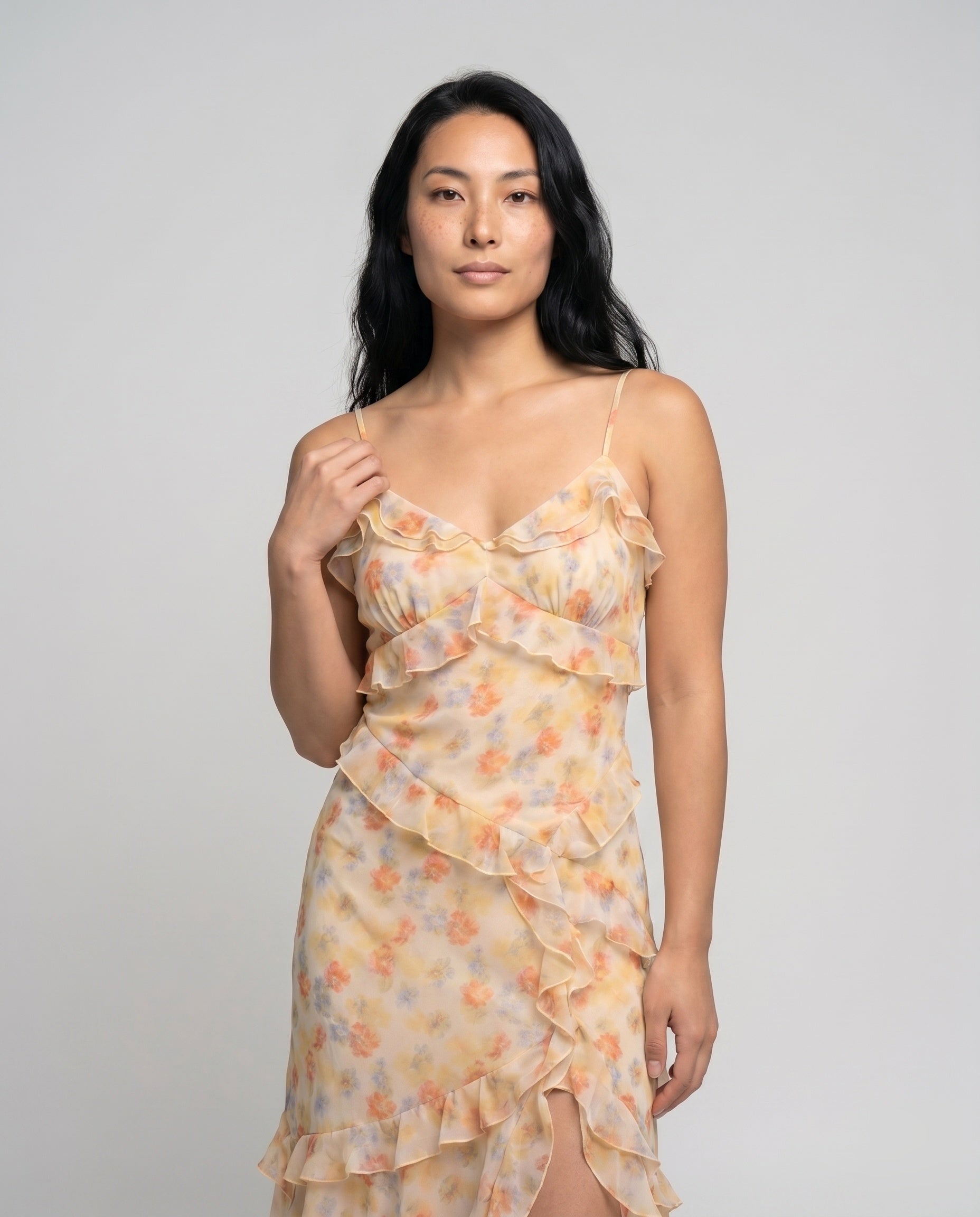 Woman wearing a floral dress against a plain background