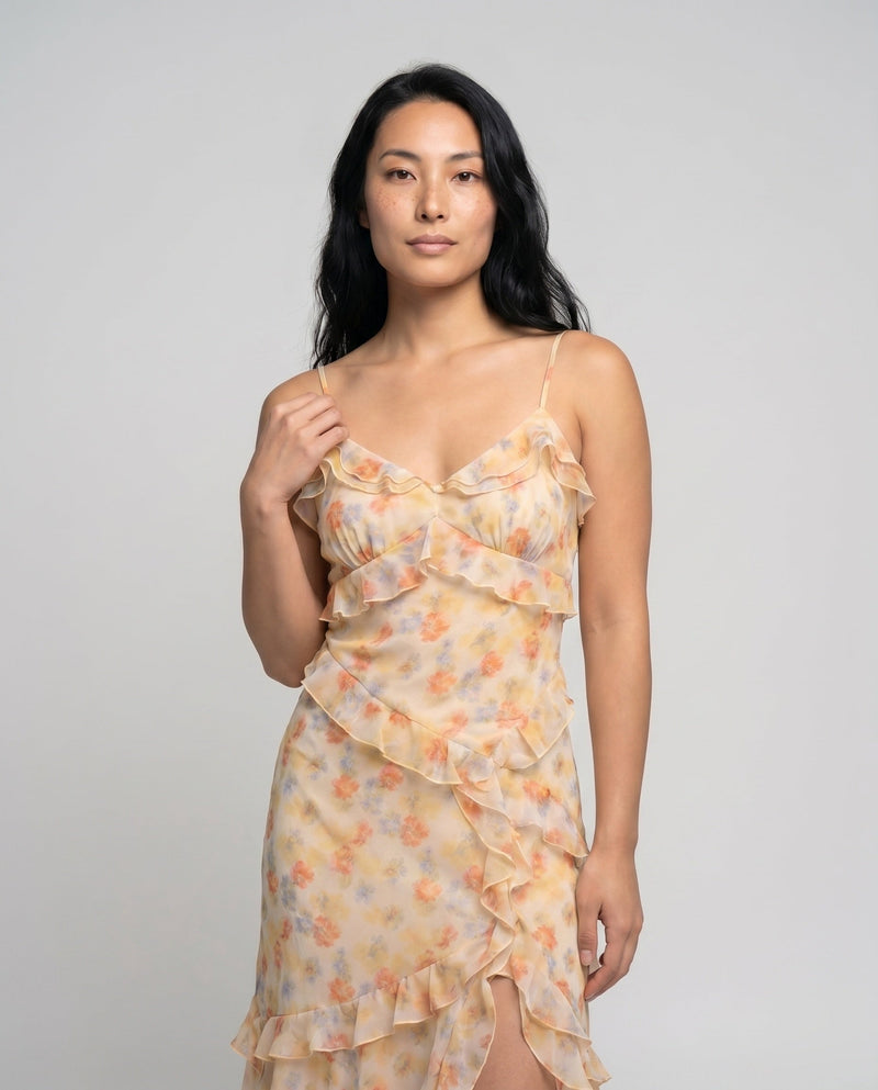 Woman wearing a floral dress against a plain background