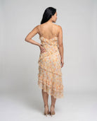 Woman wearing a floral dress on a plain background