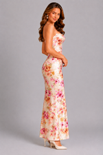 Woman wearing a floral strapless gown on a gray background