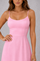 Pink dress worn by a model against a gray background