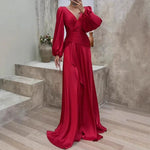 Red evening gown with long sleeves on a neutral background