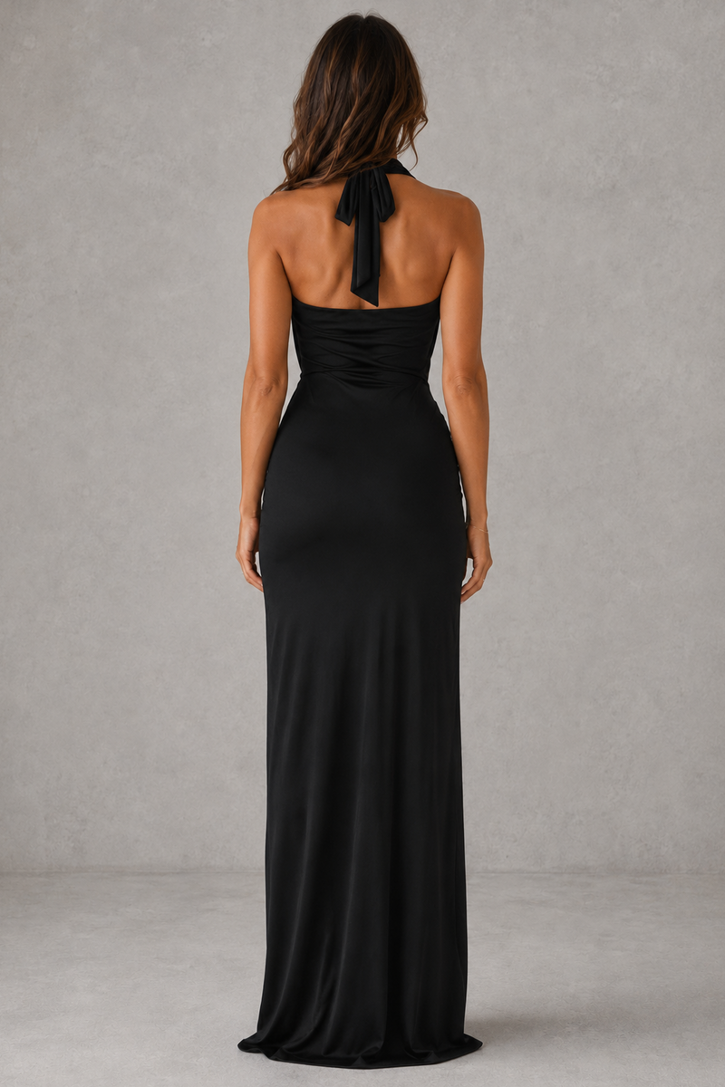 Woman wearing a black halter neck gown against a gray background
