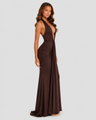 Woman wearing a brown evening gown on a plain background