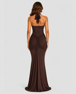 Brown evening gown with a draped design on a white background