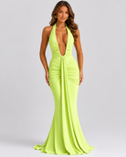 Woman wearing a bright green evening gown on a gray background