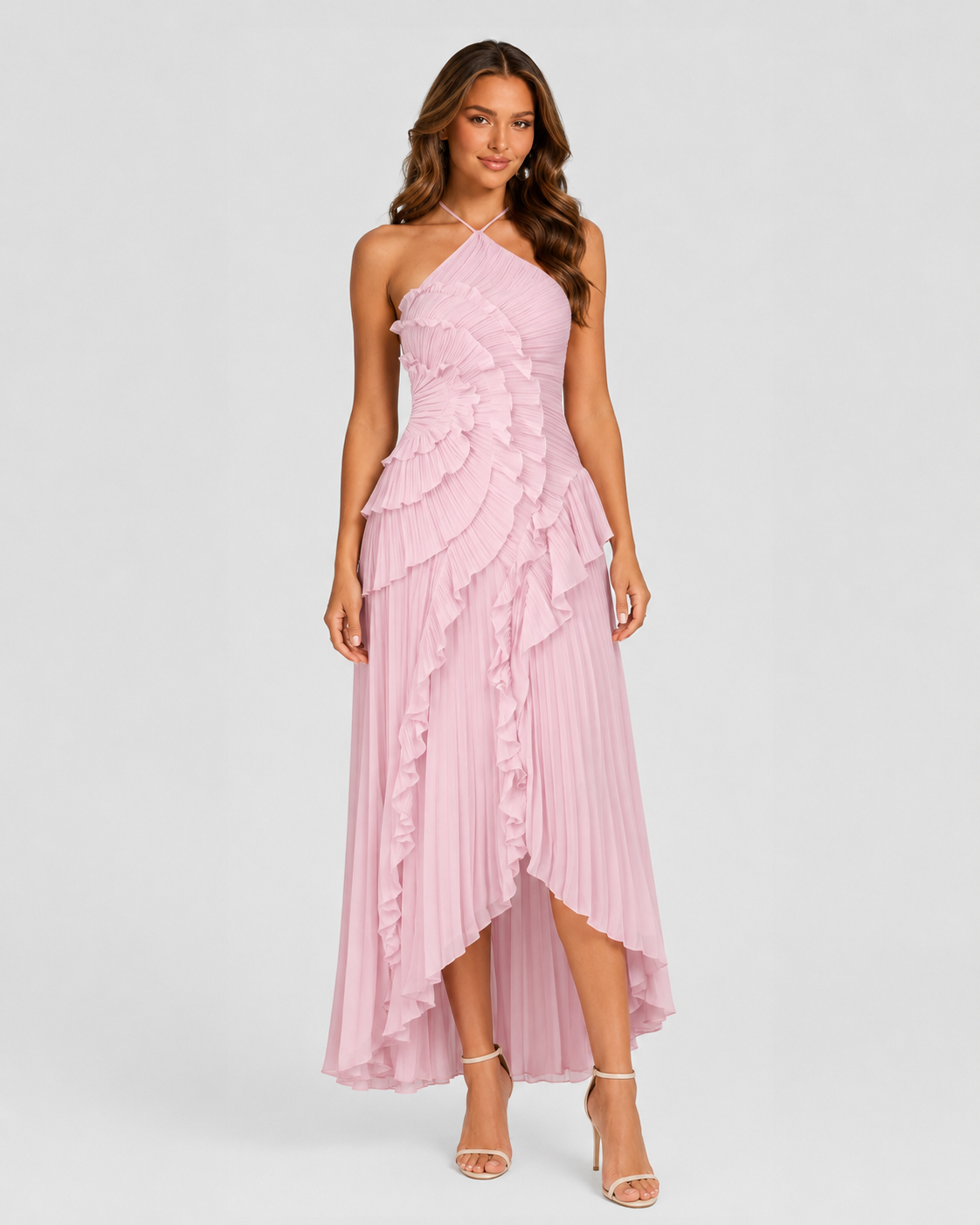 Woman wearing a pink one-shoulder dress with ruffled layers on a white background