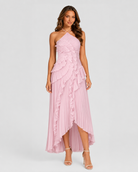 Woman wearing a pink one-shoulder dress with ruffled layers on a white background