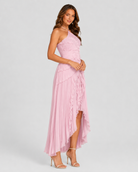 Woman wearing a pink one-shoulder dress on a white background