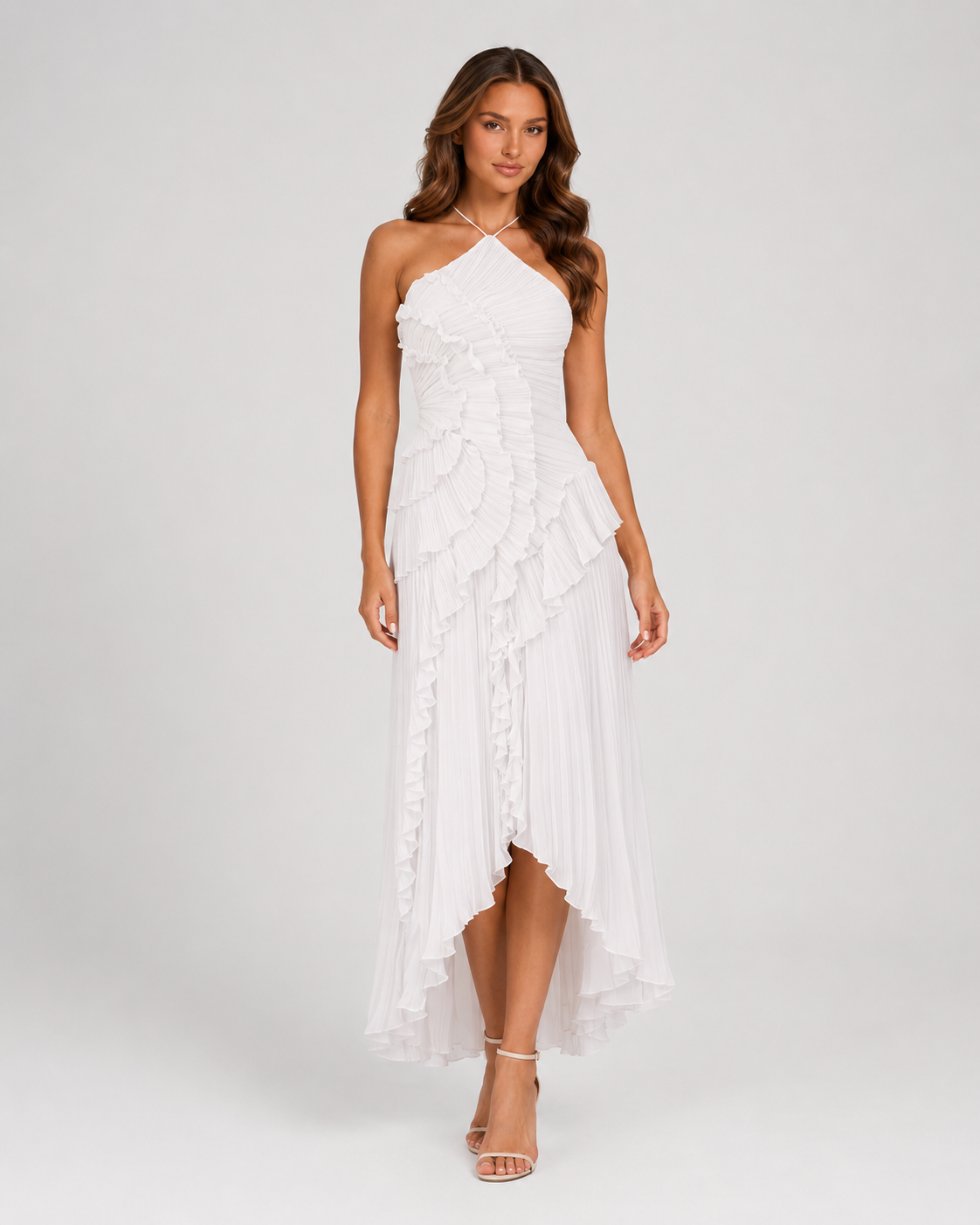 Woman wearing a white halter neck dress with floral details on a white background