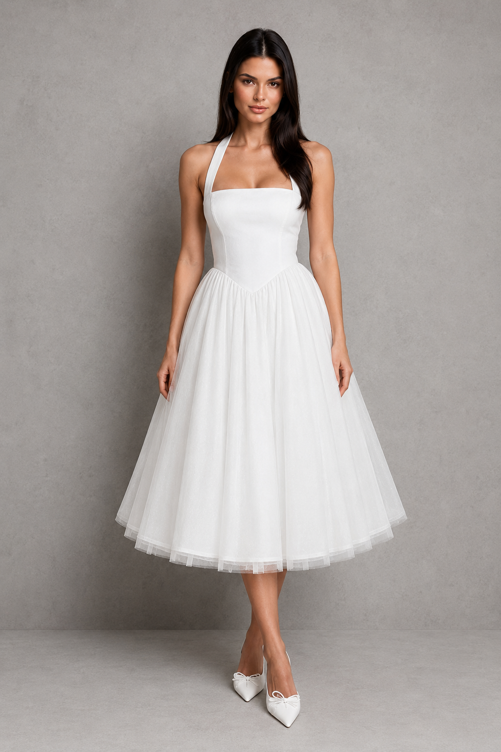 Woman wearing a white halter neck dress against a gray background
