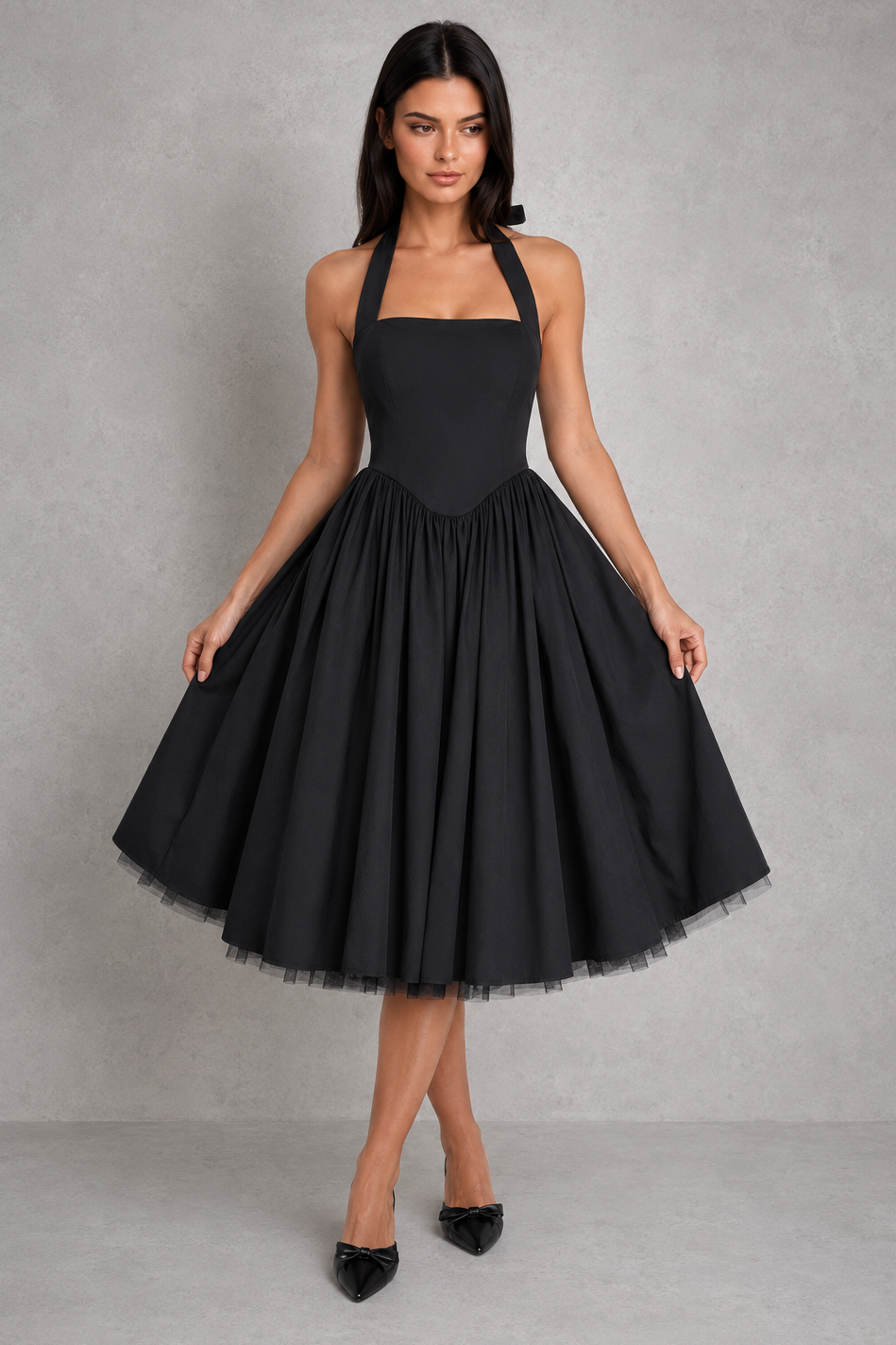 Woman wearing a white halter neck dress against a gray background
