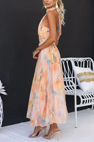 Women’s halter neck maxi dress with watercolor print and open back
