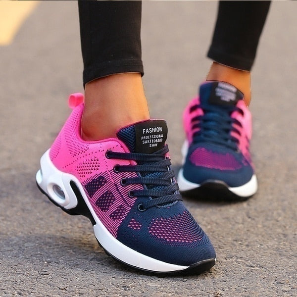 Pink and blue running shoes on a neutral background