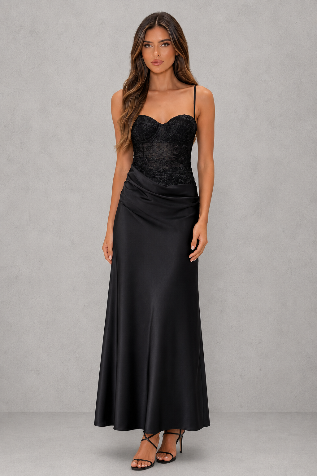 Woman wearing a black evening gown against a gray background
